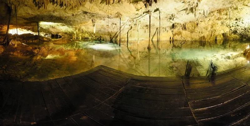 Wooden platform at the water's edge inside the cave